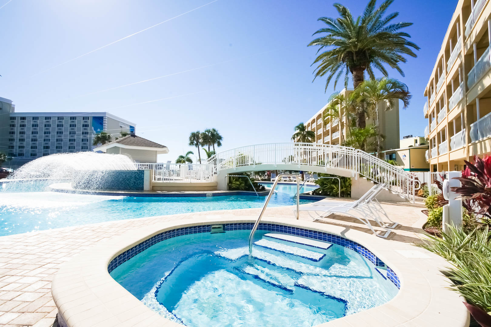 An outdoor pool and Jacuzzi tub at VRI's Coral Reef Beach Resort in St. Pete Beach, Florida.